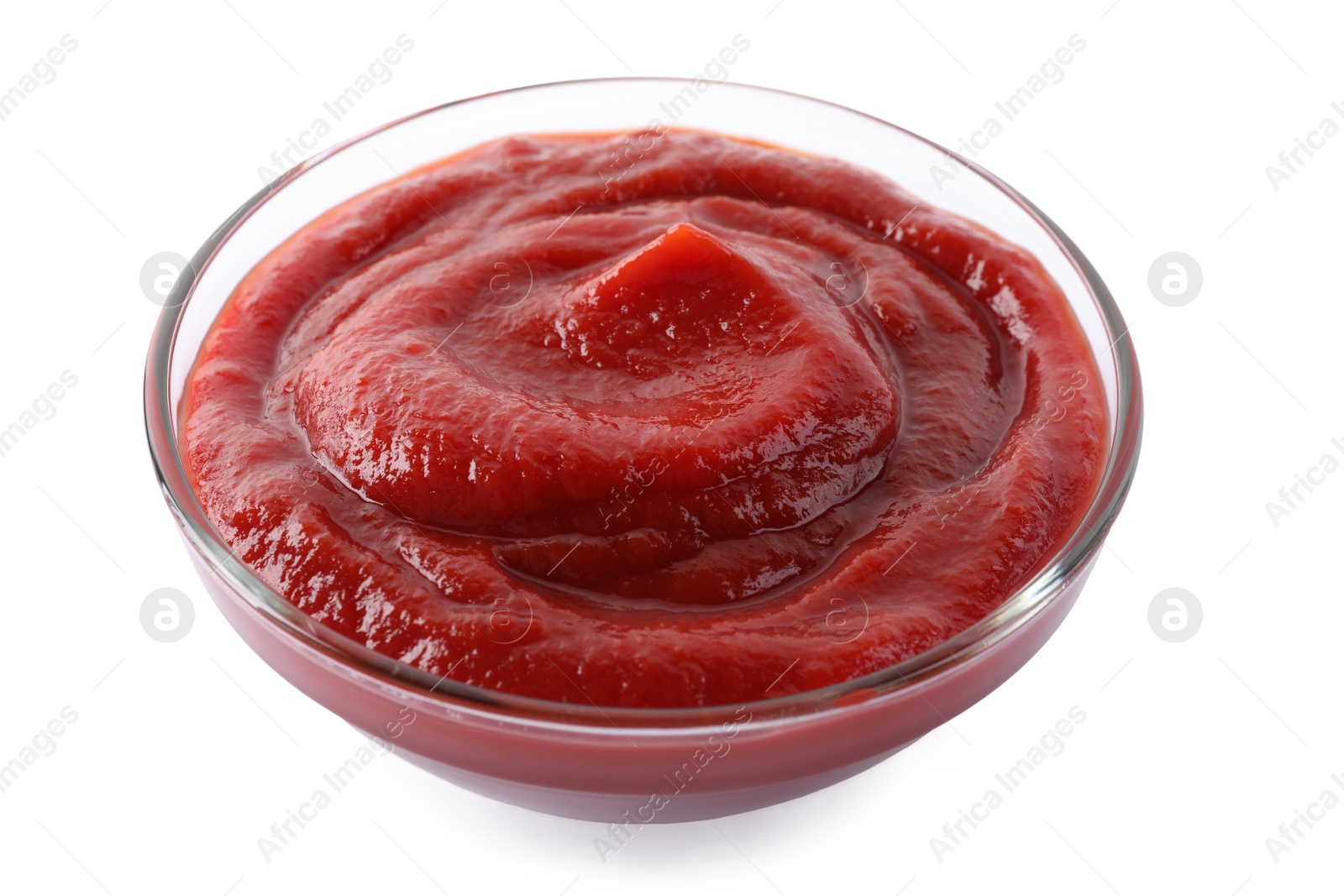 Photo of Tasty ketchup in glass bowl isolated on white, closeup