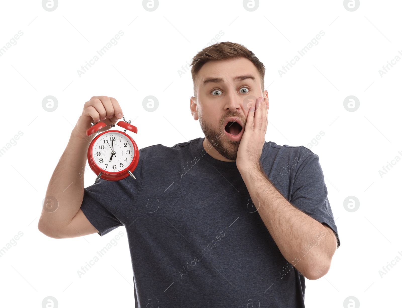 Photo of Emotional overslept man with alarm clock on white background. Being late concept