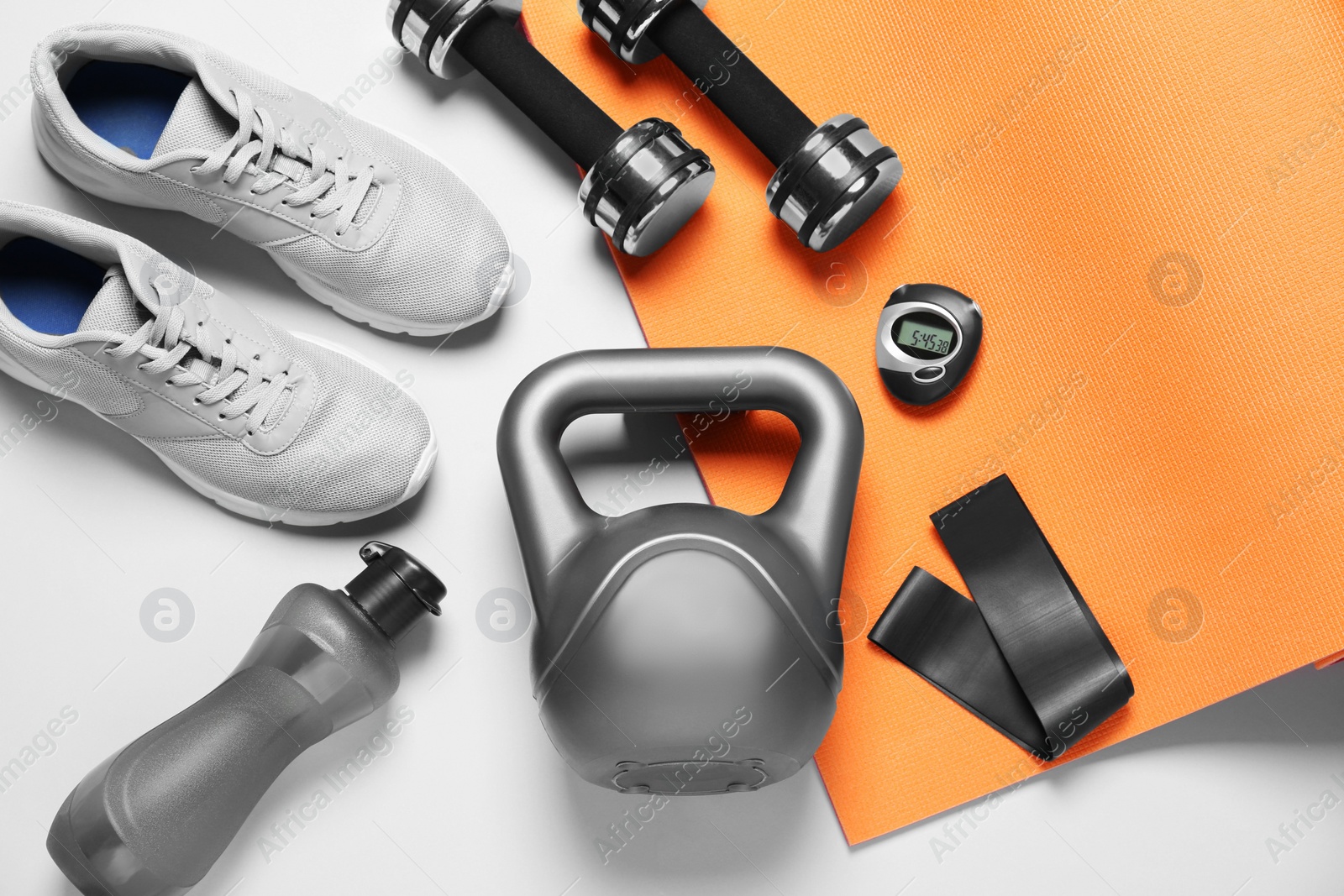 Photo of Exercise mat and other sport equipment on white background, flat lay