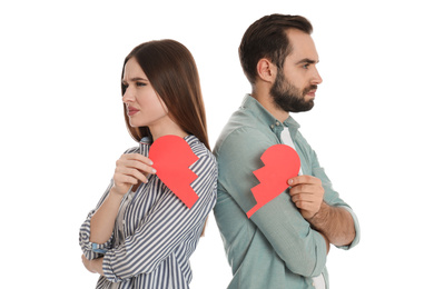 Photo of Couple with torn paper heart on white background. Relationship problems