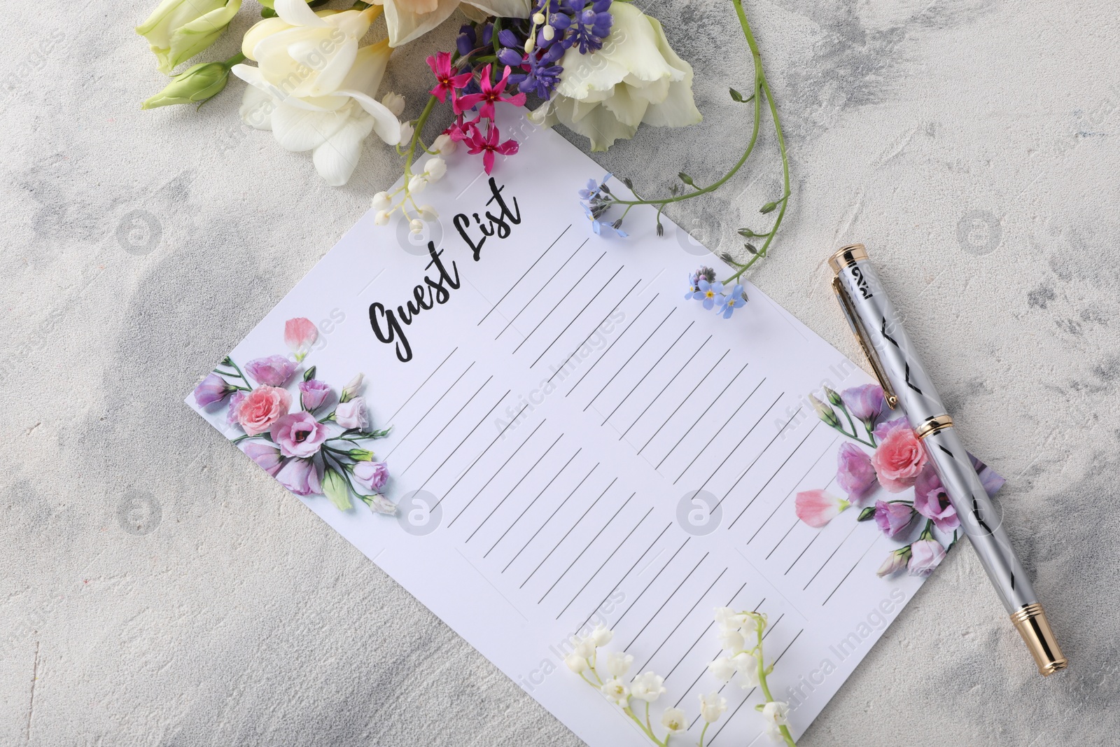 Photo of Guest list, pen and beautiful flowers on light textured background, flat lay. Space for text