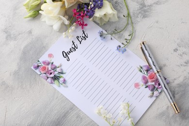 Guest list, pen and beautiful flowers on light textured background, flat lay. Space for text