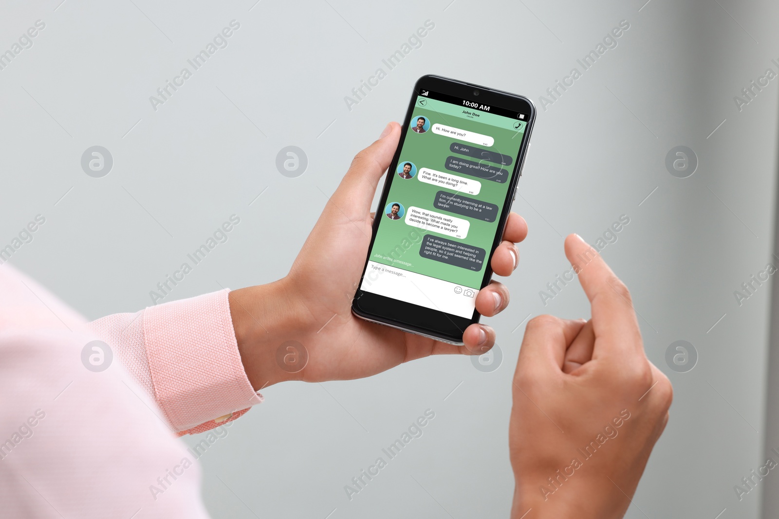 Image of Man texting with friend using messaging application on smartphone against light grey background, closeup