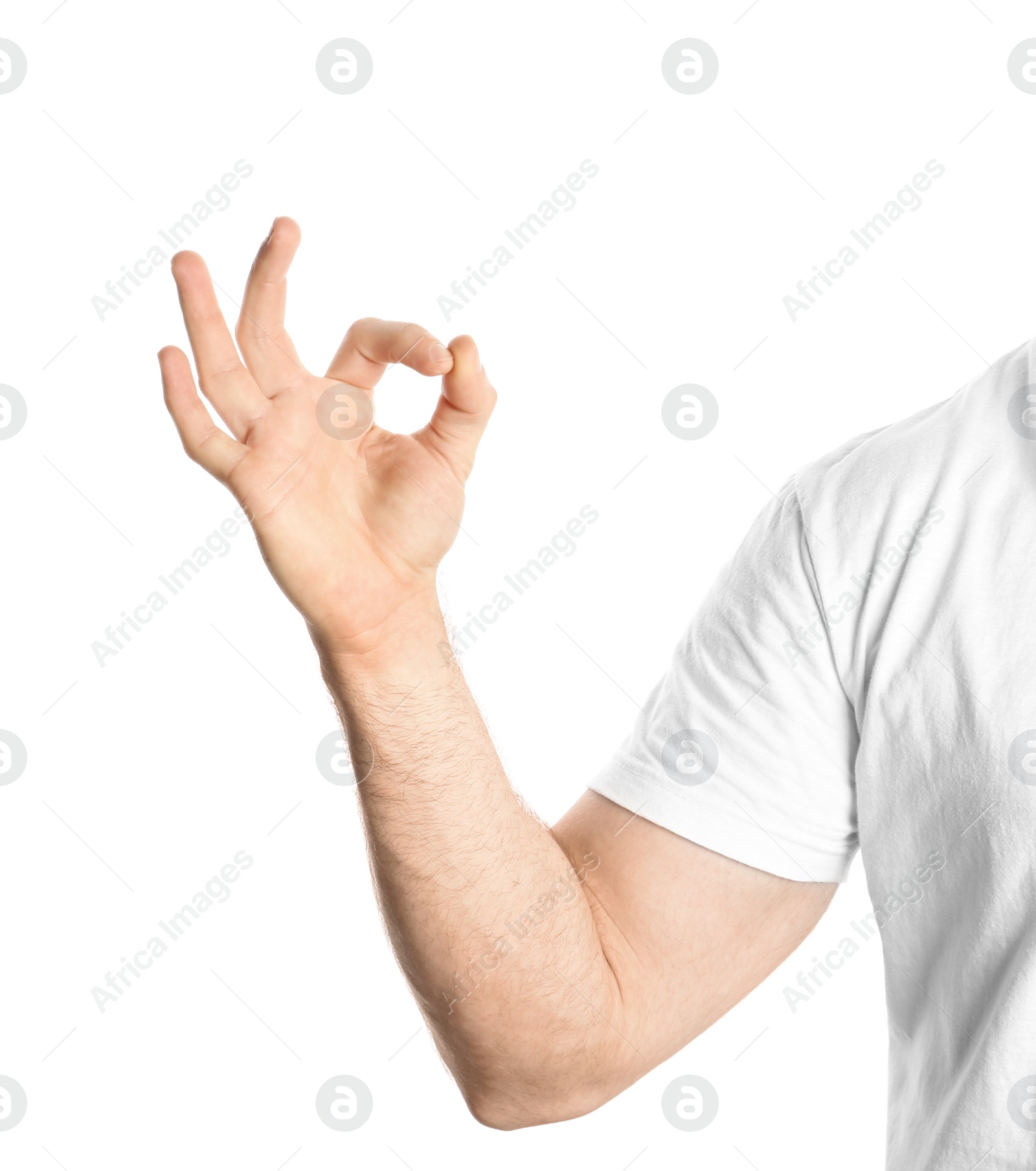 Photo of Young man showing OK gesture on white background