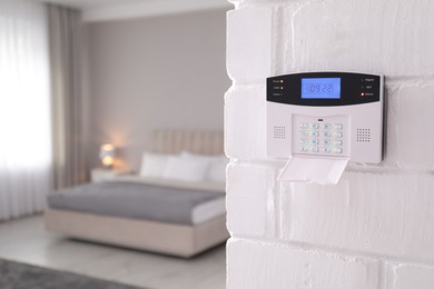 Home security system on white wall indoors, space for text
