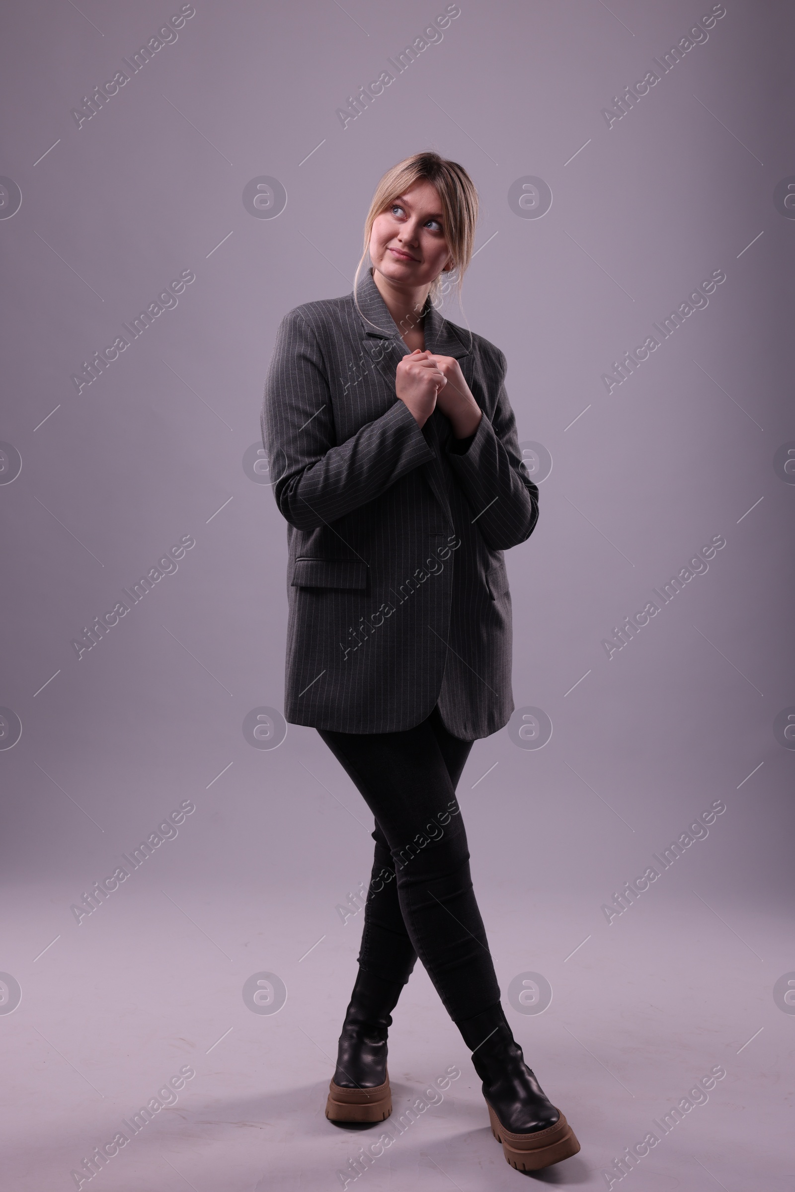 Photo of Full length portrait of beautiful young woman on grey background