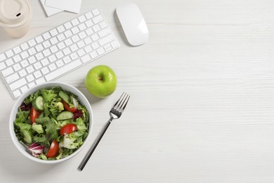 Bowl of tasty food, keyboard, apple and fork on white wooden table, flat lay with space for text. Business lunch