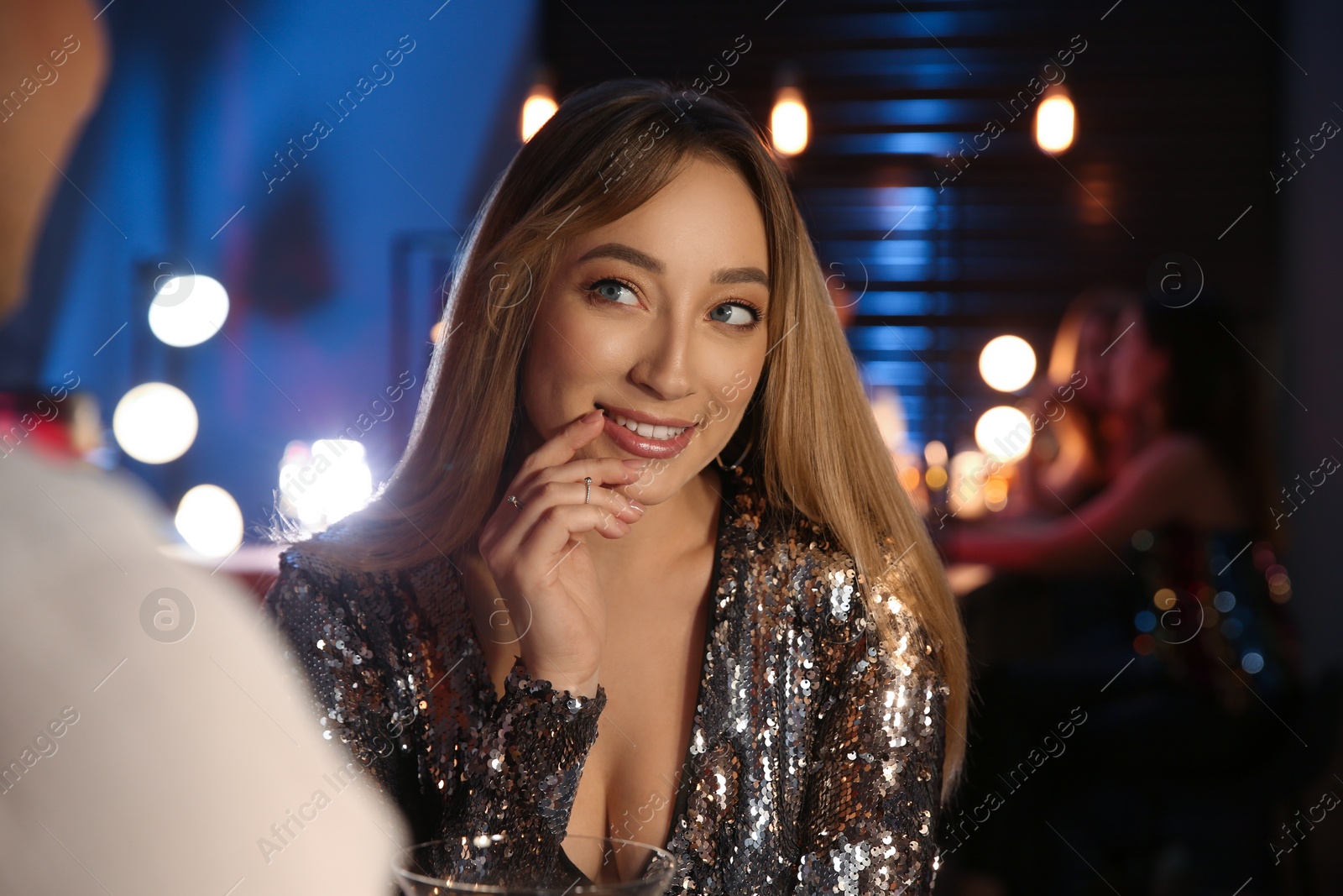 Photo of Beautiful woman flirting with man in bar