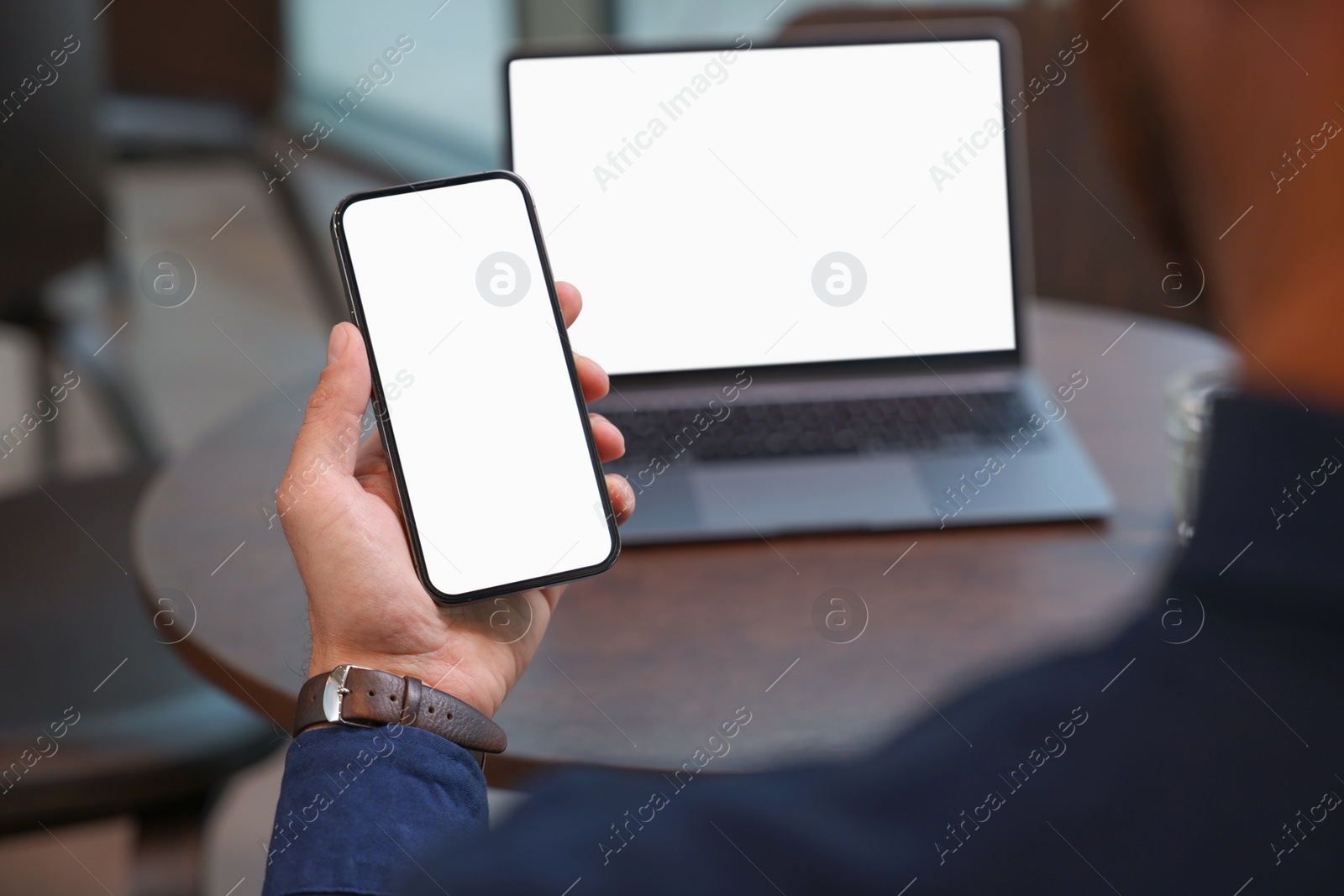 Photo of Man using smartphone at table in cafe, closeup