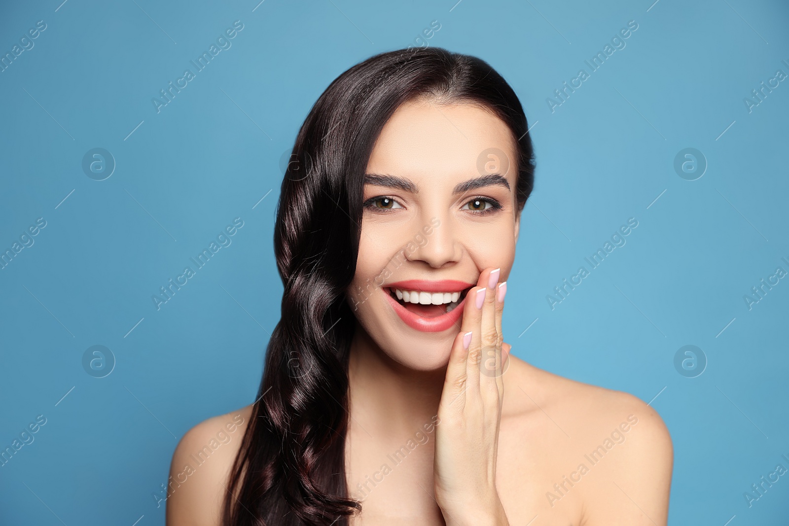 Photo of Portrait of surprised woman on blue background