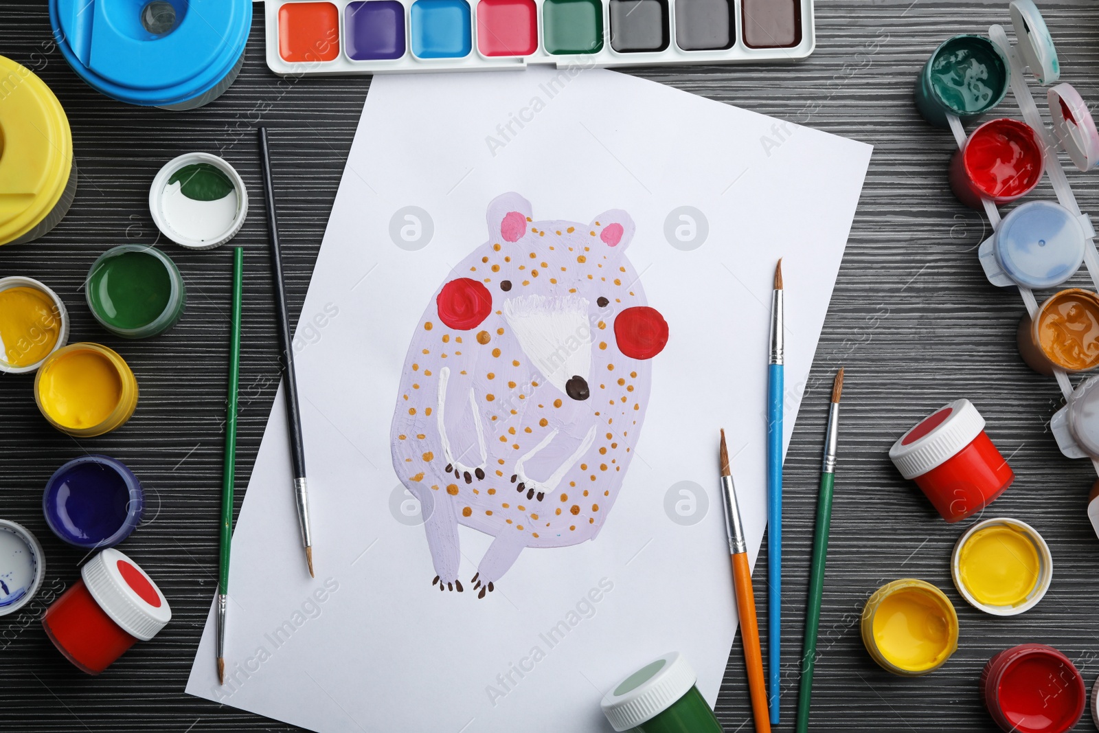 Photo of Flat lay composition with child's painting of bear on grey wooden table