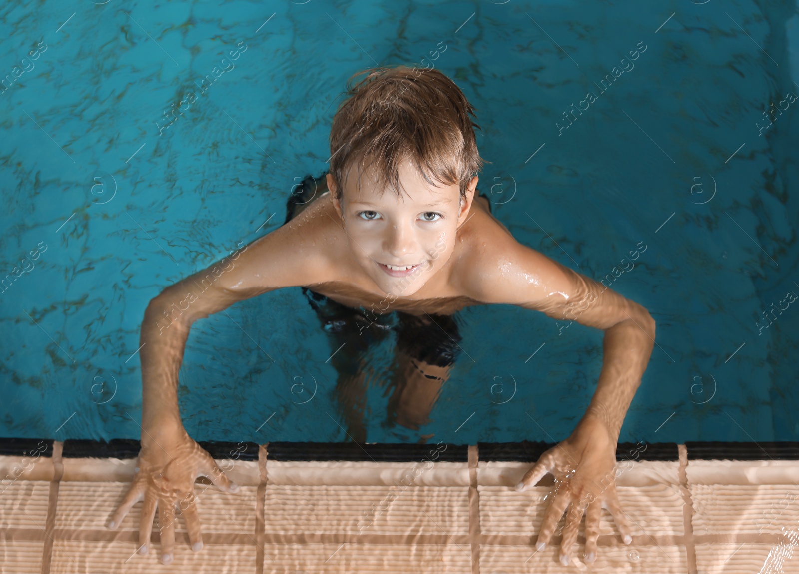 Photo of Cute little boy in indoor swimming pool