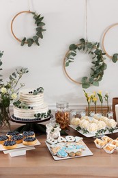 Photo of Beautiful cake and other treats on table in room. Baby shower party