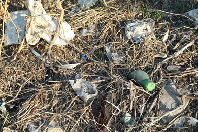 Photo of Different plastic garbage outdoors. Environmental pollution concept