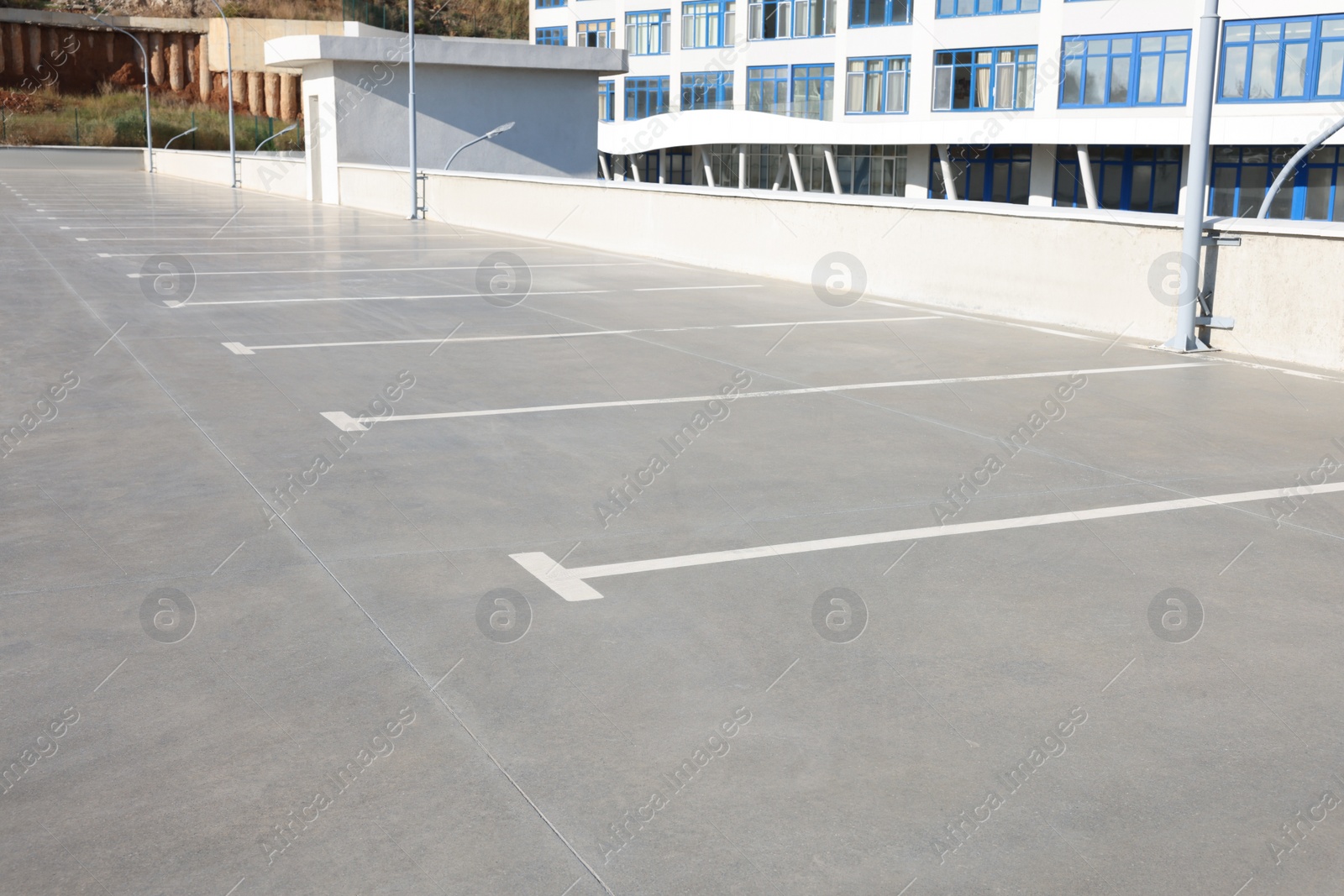 Photo of Outdoor car parking lot with white marking lines 