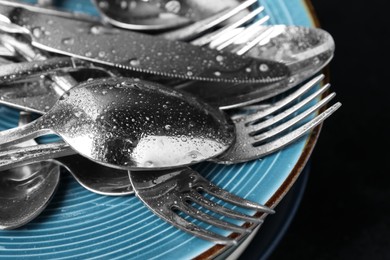 Photo of Different kitchenware after washing on black table, closeup
