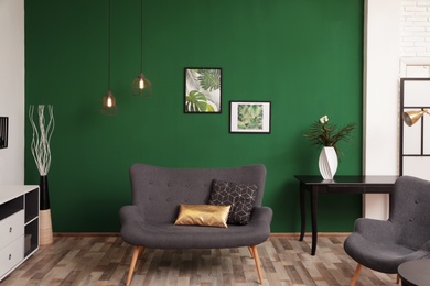 Photo of Modern living room interior stylish sofa near green wall