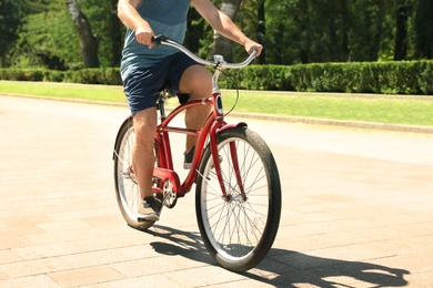 Man riding bike outdoors on sunny day