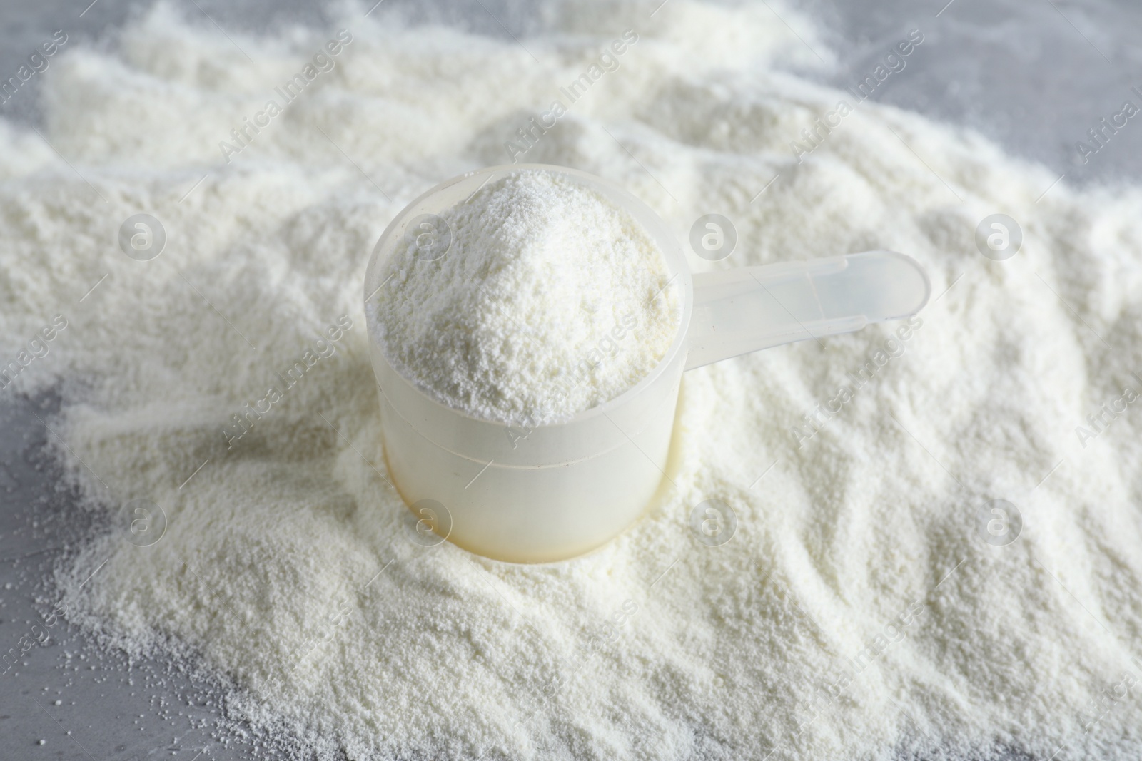 Photo of Scoop and pile of protein powder on table