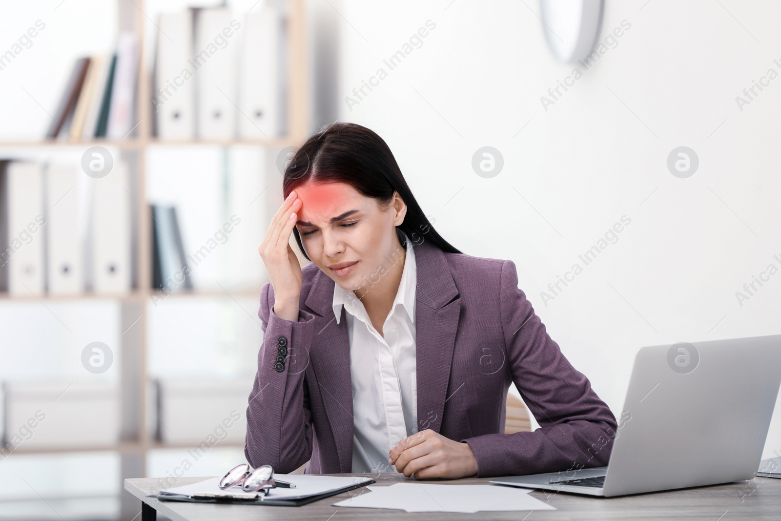 Image of Woman suffering from migraine at workplace in office