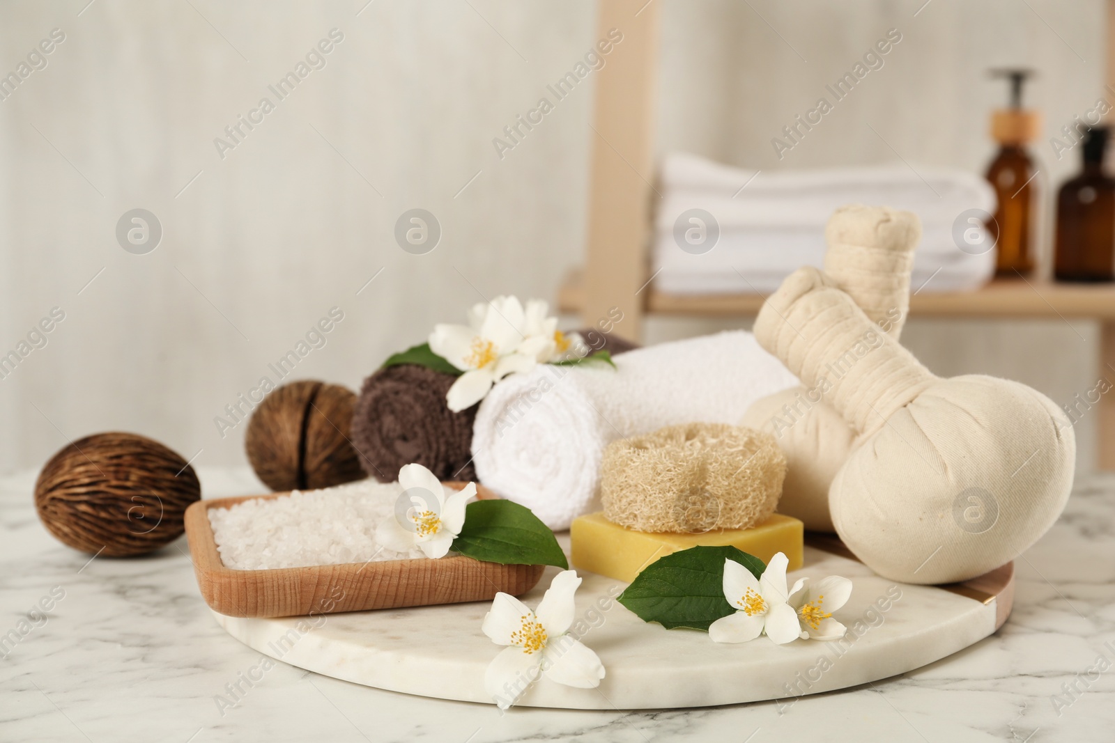 Photo of Composition with beautiful jasmine flowers and sea salt on white marble table indoors