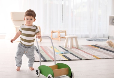 Cute baby learning to walk and playing at home