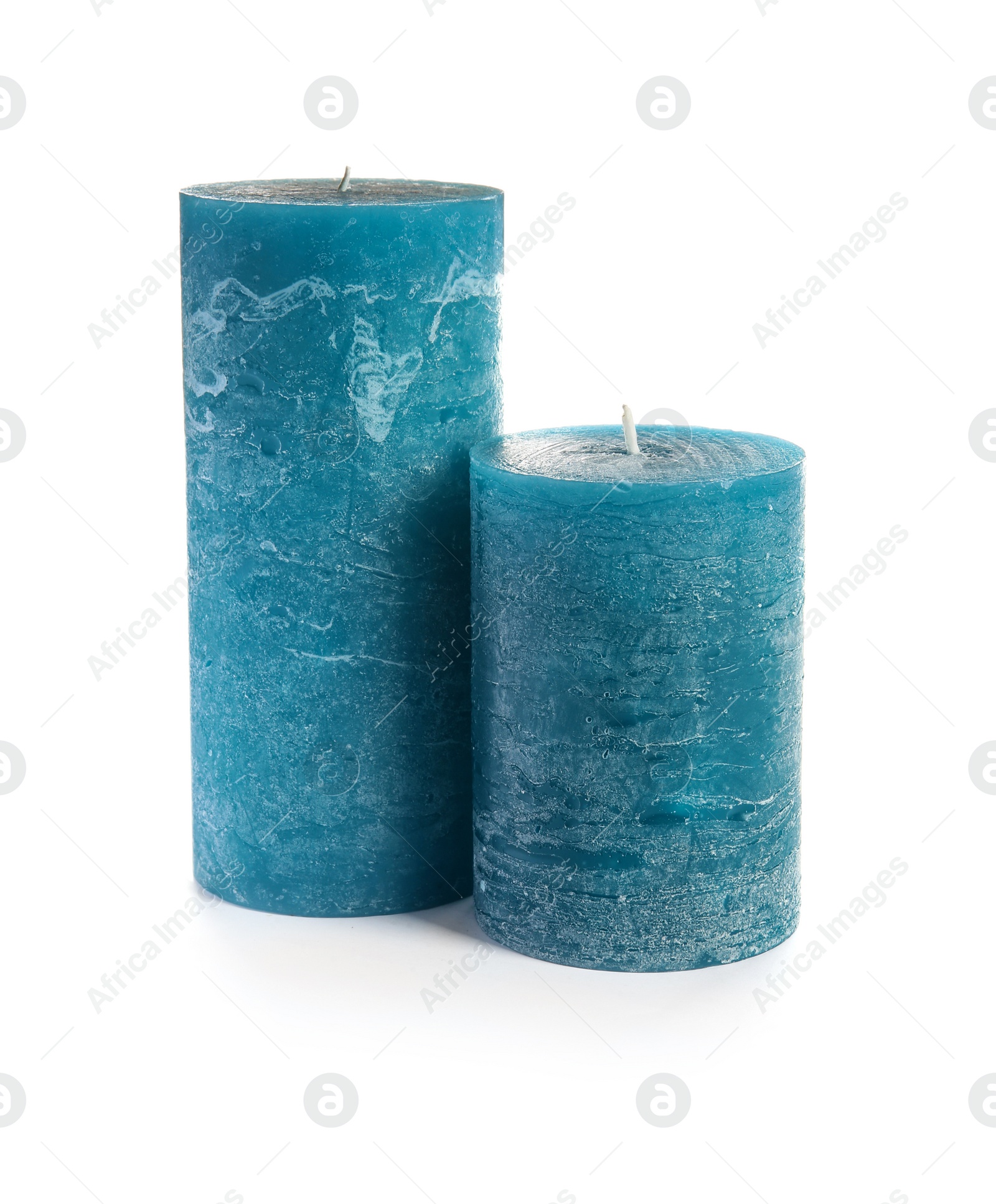 Photo of Two decorative blue wax candles on white background