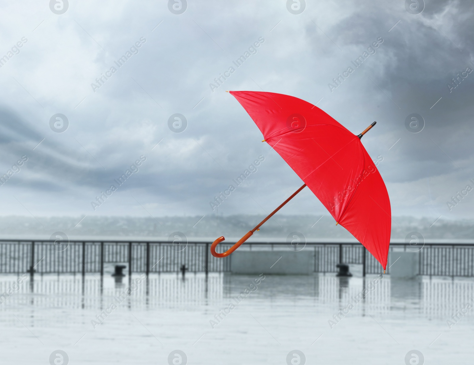 Image of Open umbrella blown by wind gust outdoors