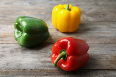 Raw ripe paprika peppers on wooden background