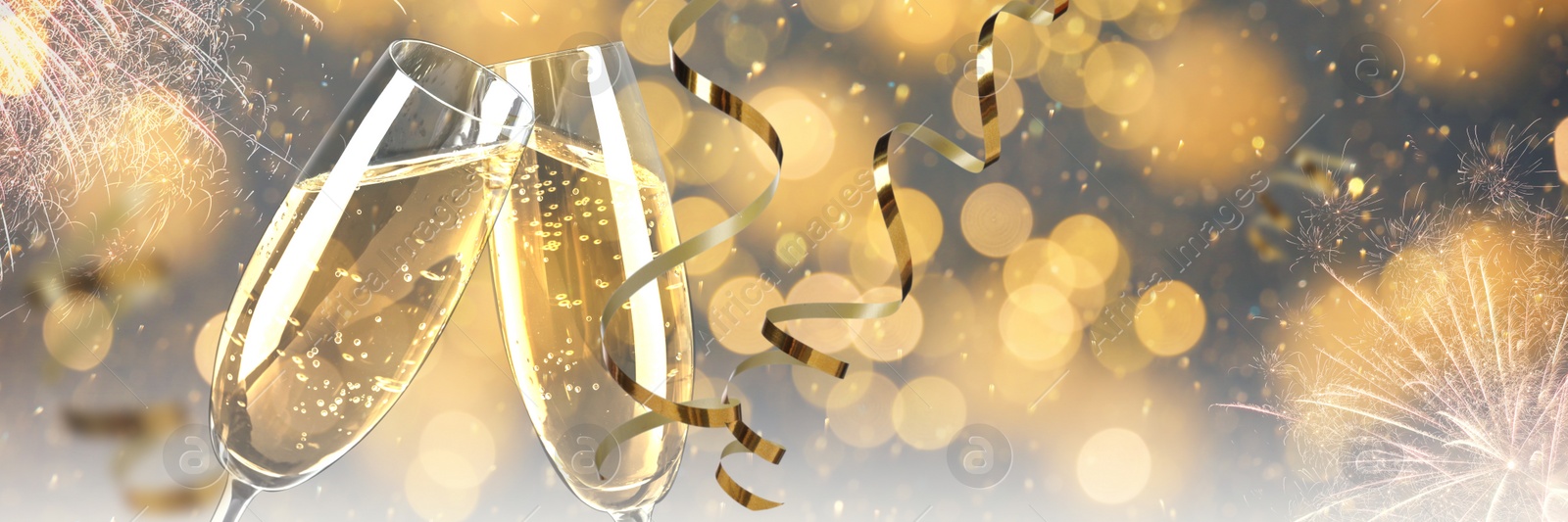 Image of Glasses with sparkling wine and shiny serpentine streamers against blurred festive lights, space for text. Banner design