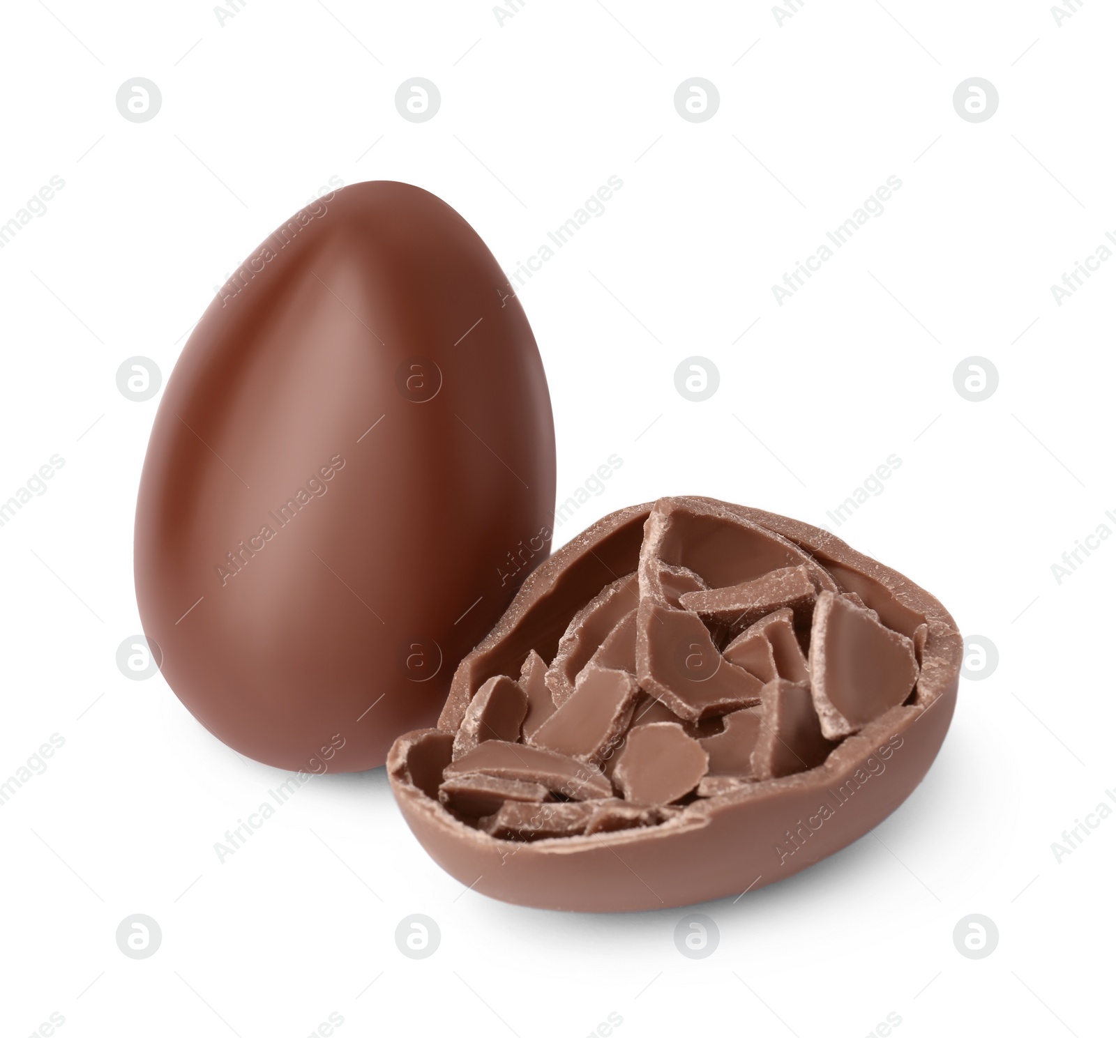 Photo of Whole and broken chocolate eggs isolated on white