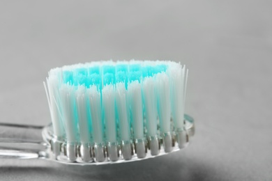 Photo of Manual toothbrush on gray background, close up