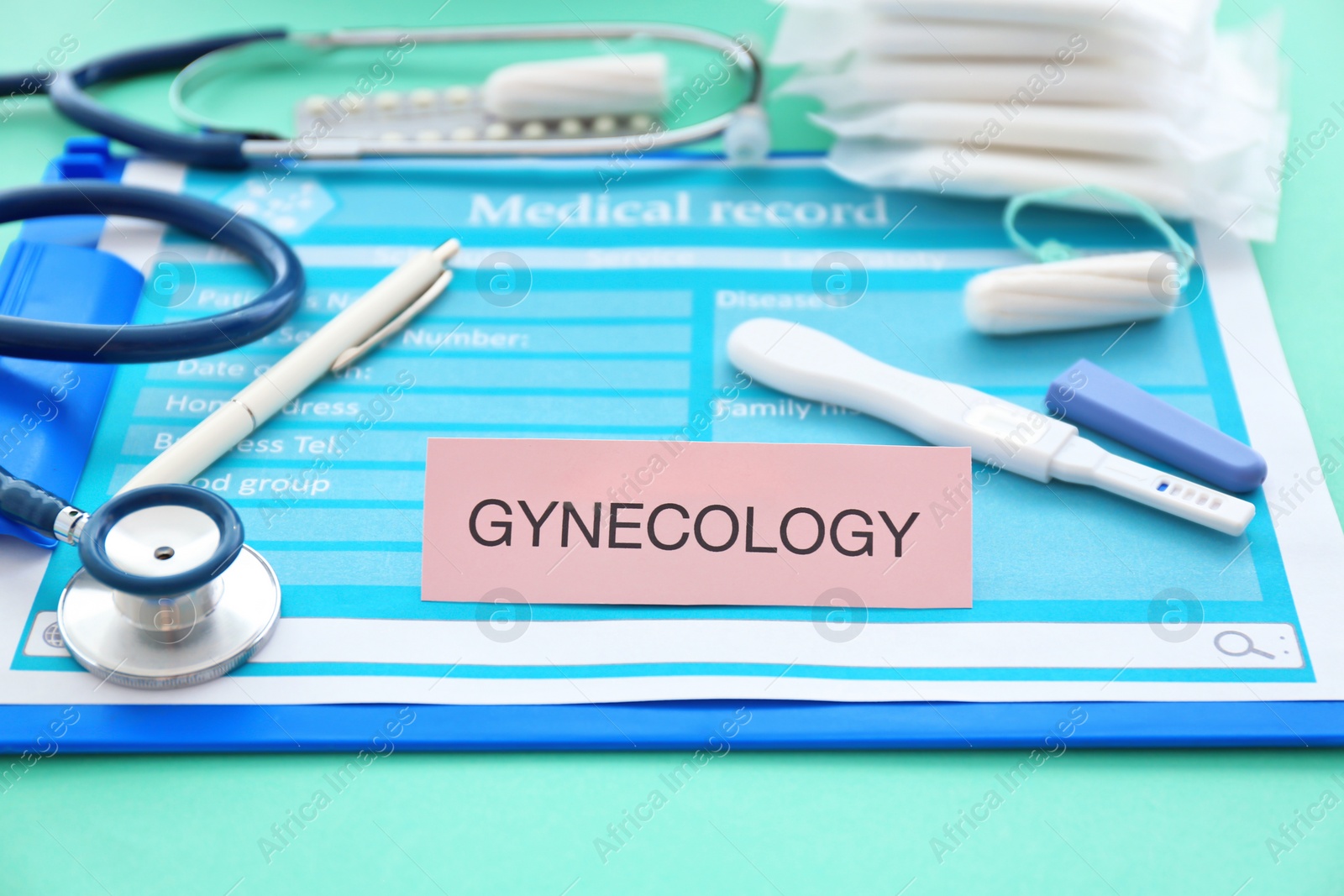 Photo of Composition with clipboard, pregnancy test and stethoscope, closeup. Gynecological care