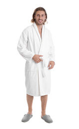 Young man in bathrobe on white background