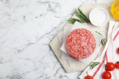 Photo of Raw hamburger patties with rosemary, salt and tomatoes on white marble table, flat lay. Space for text