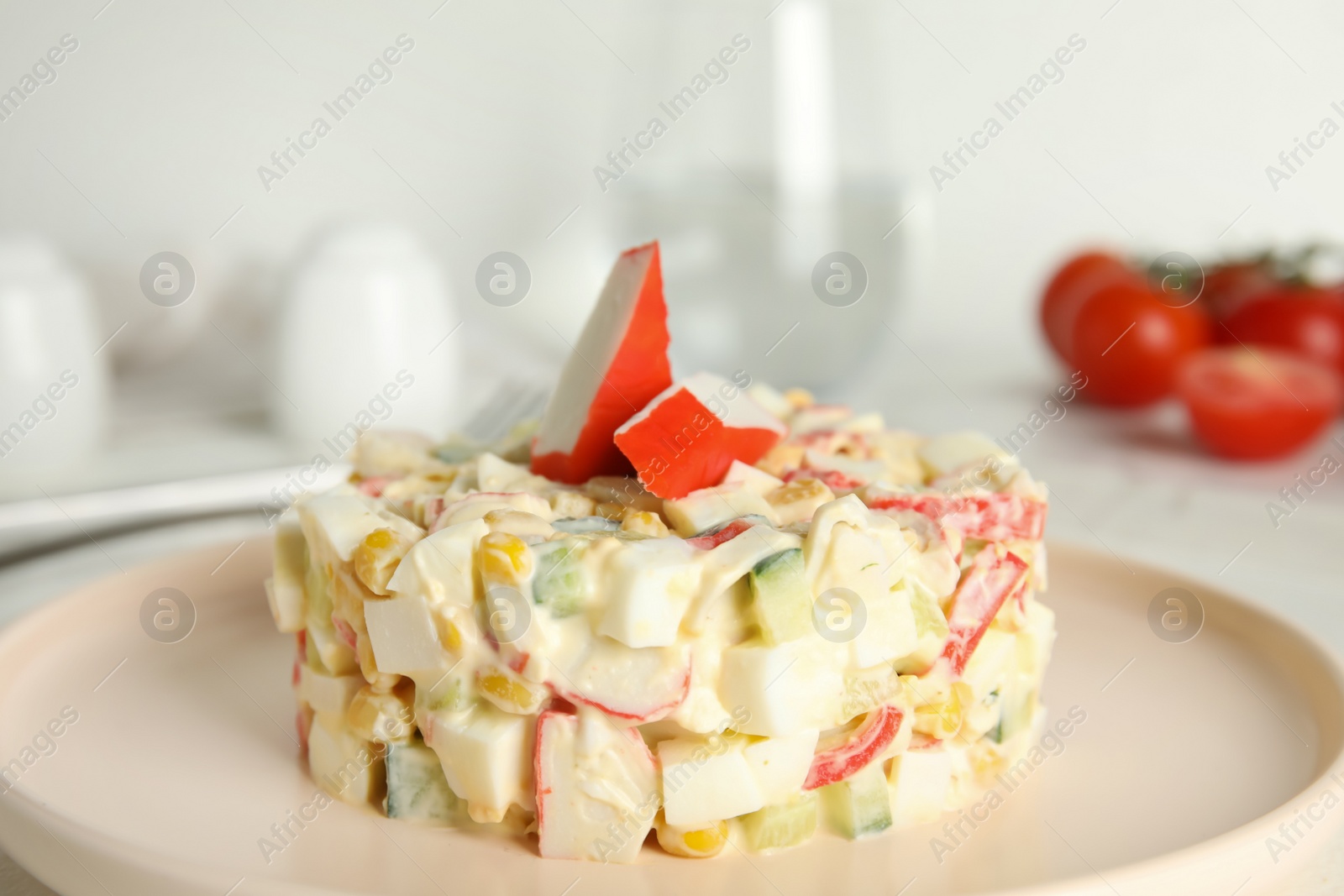 Photo of Delicious salad with fresh crab sticks on plate, closeup