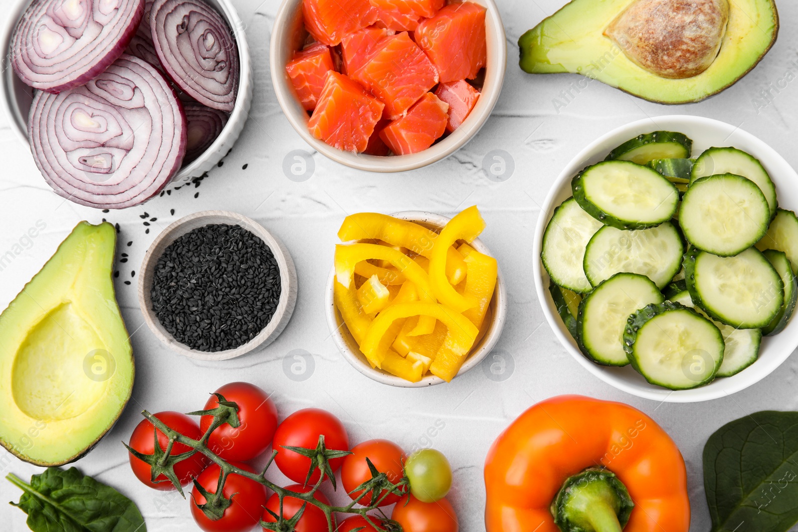 Photo of Ingredients for poke bowl on white textured table, flat lay