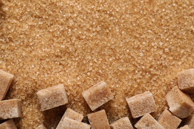 Photo of Different types of brown sugar as background, top view. Space for text