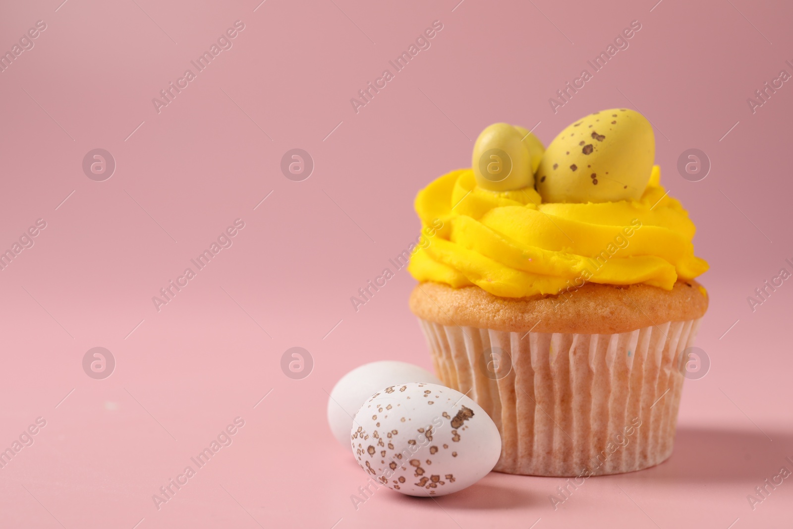 Photo of Tasty cupcake with Easter decor on pink background, closeup. Space for text