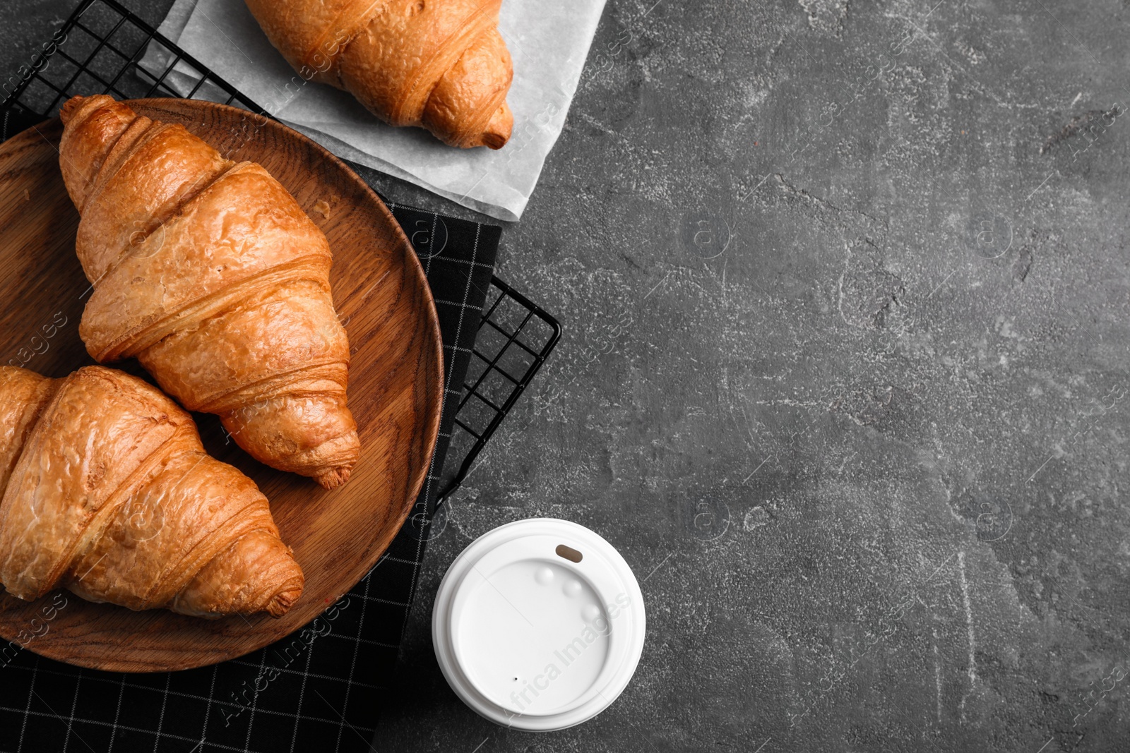 Photo of Fresh croissants and drink on grey table, flat lay. Space for text