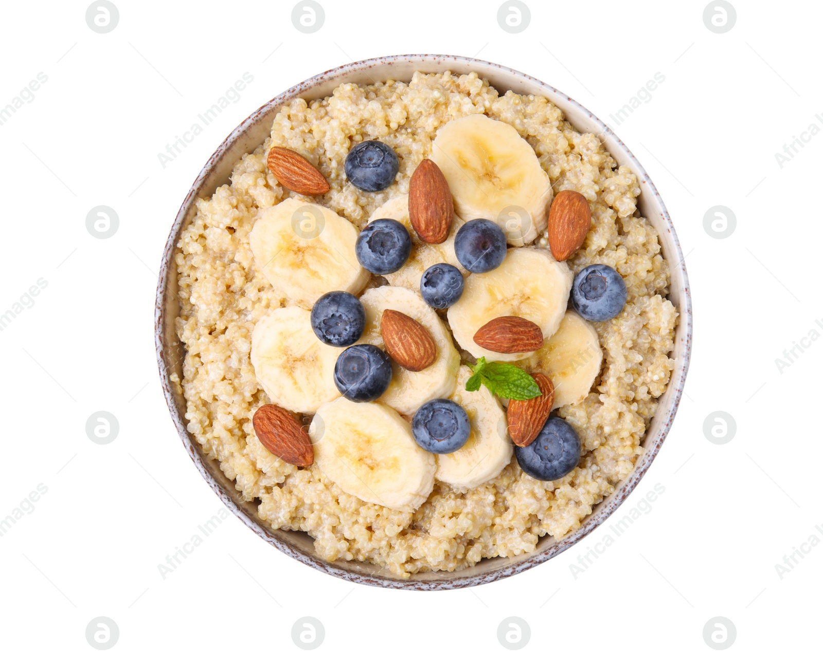 Photo of Bowl of delicious cooked quinoa with almonds, bananas and blueberries isolated on white, top view