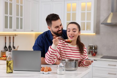 Happy lovely couple cooking together in kitchen