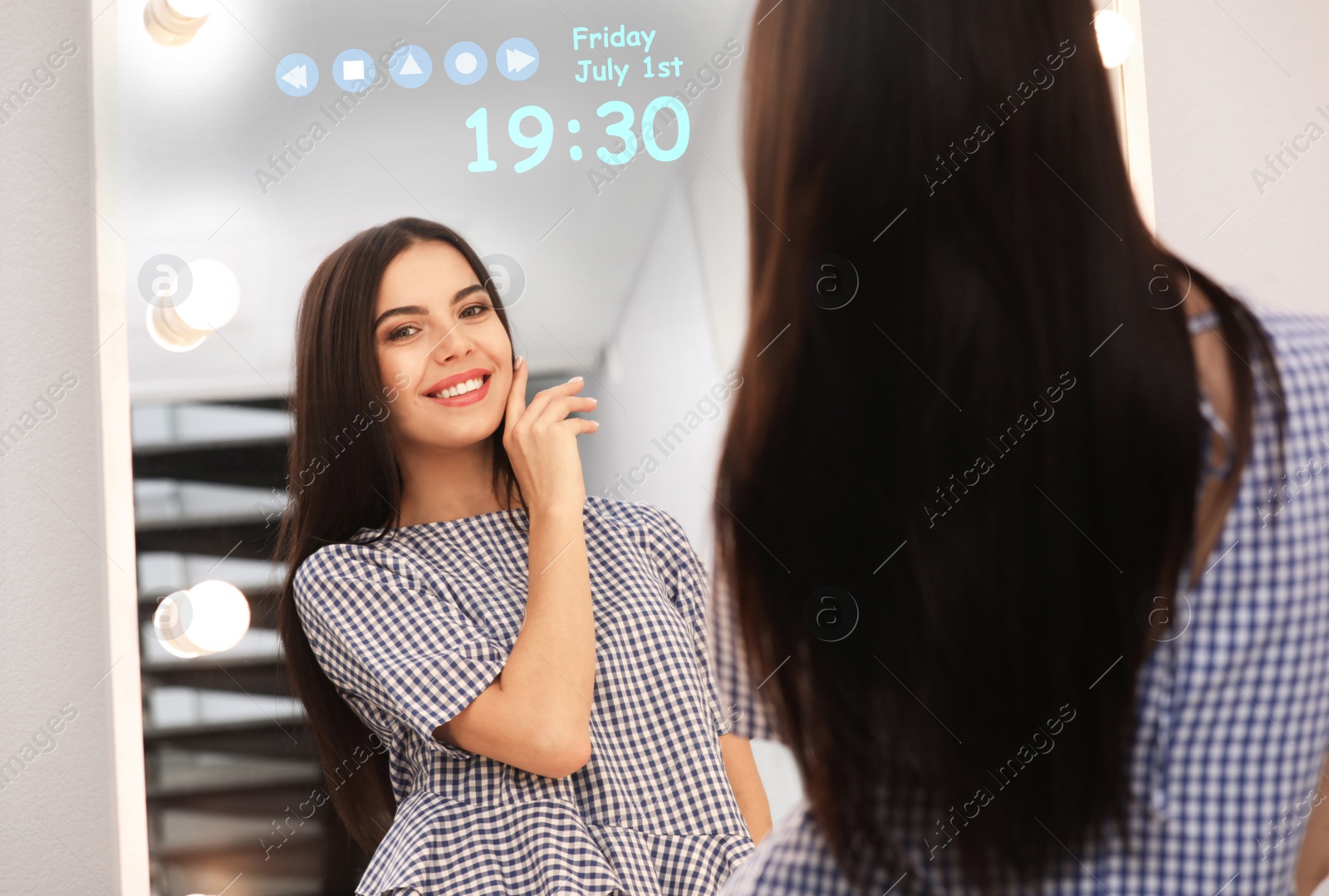 Image of Young attractive woman looking at herself in smart mirror at home