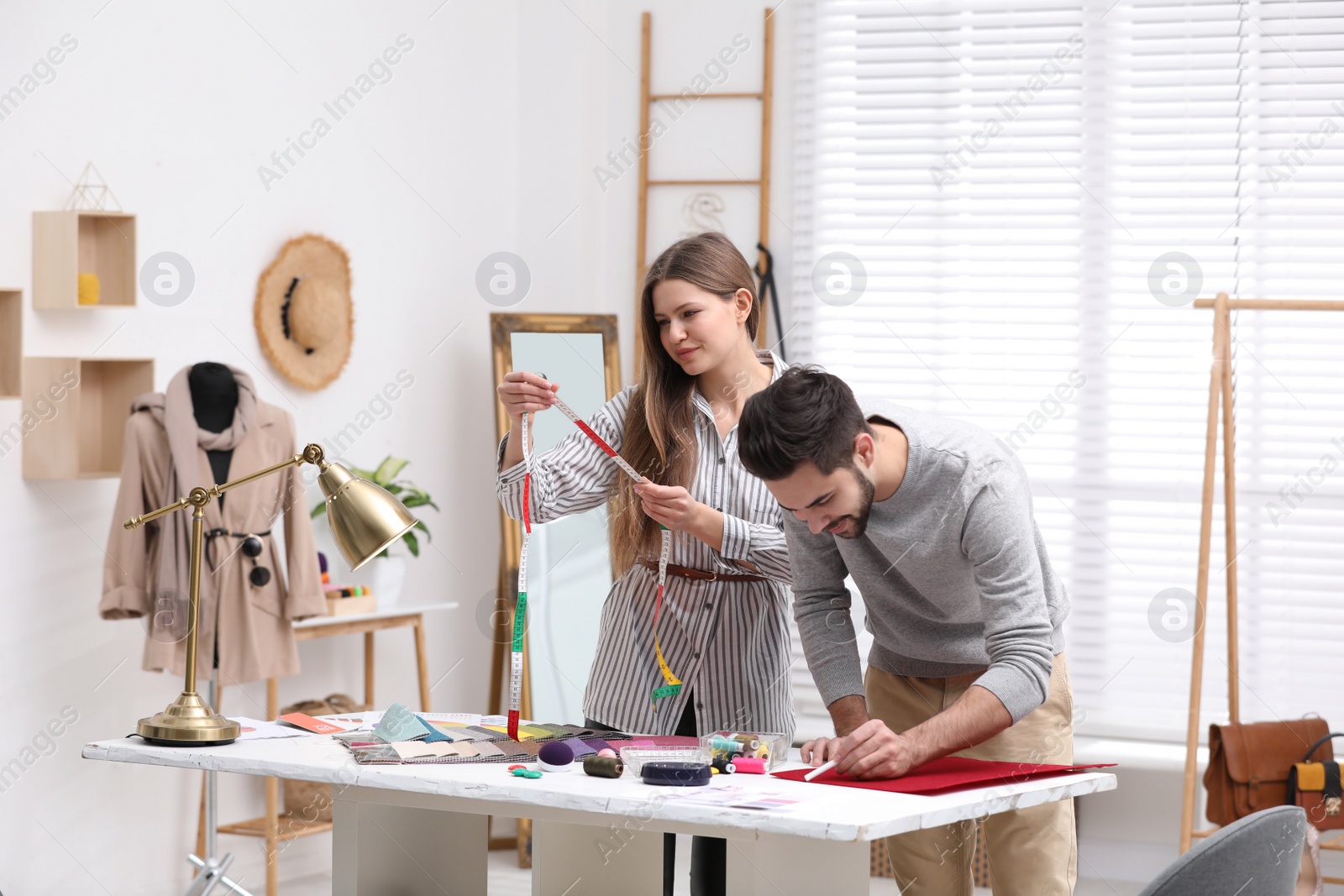 Photo of Fashion designers creating new clothes in studio