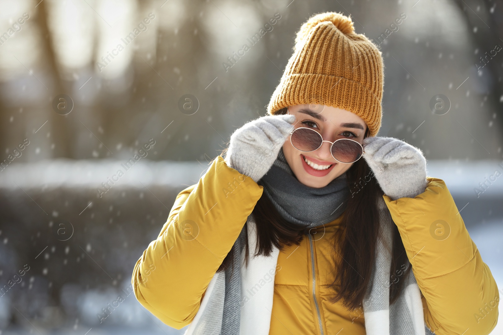 Photo of Portrait of beautiful young woman with sunglasses on winter day outdoors