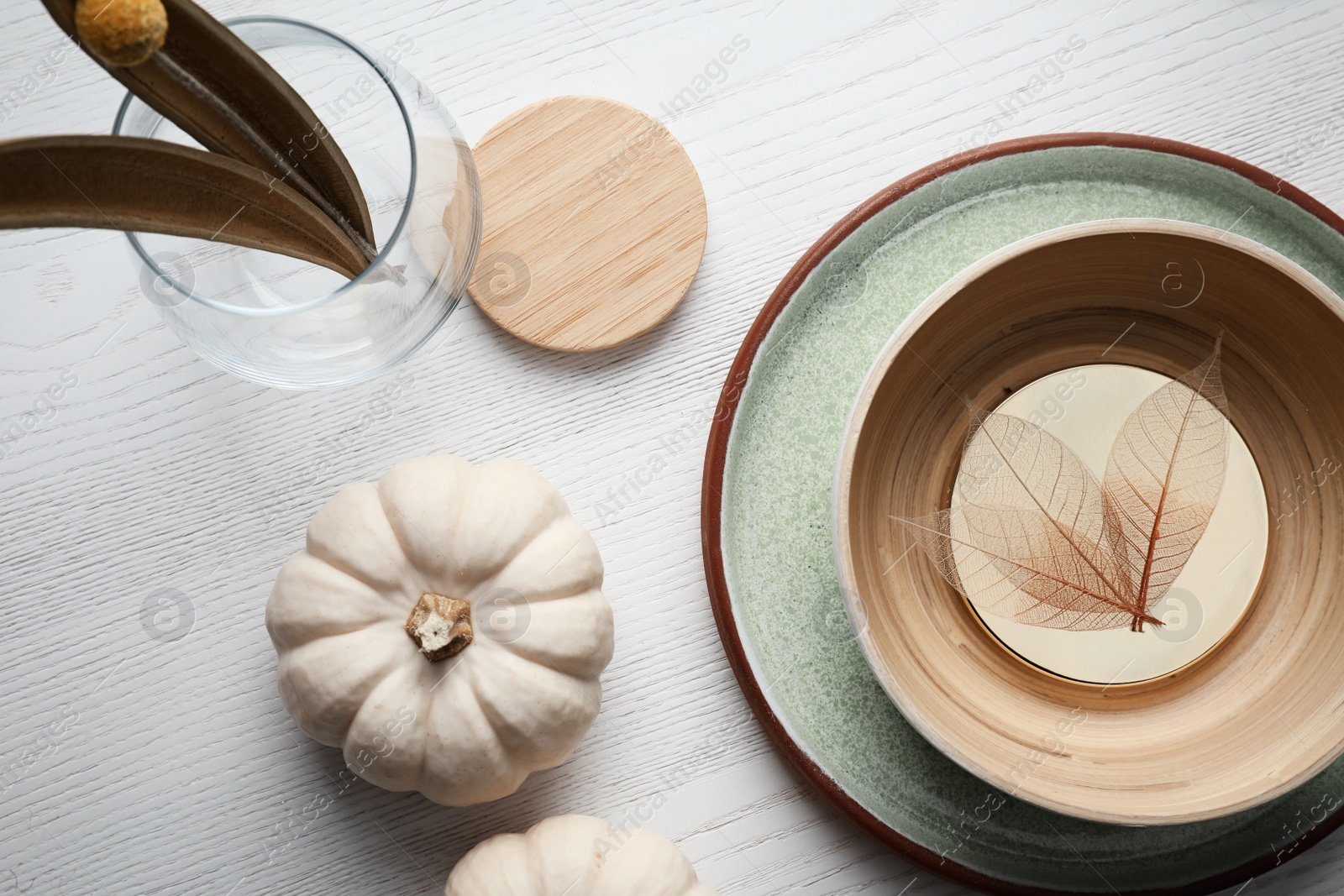 Photo of Autumn table setting with pumpkins on white wooden background, flat lay