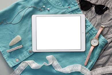 Photo of Flat lay composition with modern tablet on light grey background. Space for text