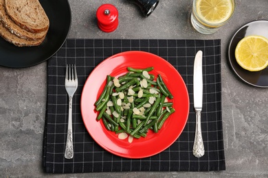 Photo of Tasty green beans with almonds served for dinner on table, top view