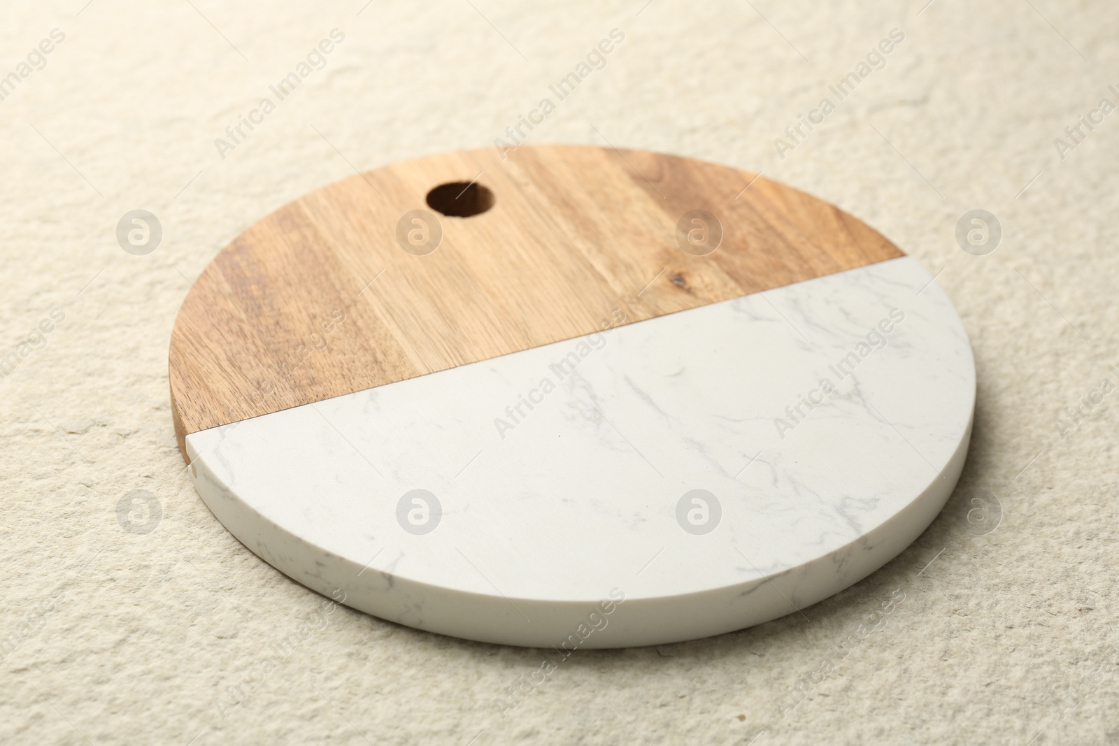 Photo of One serving board on beige table, closeup