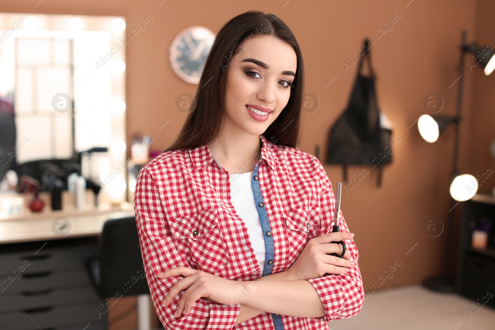 Photo of Professional hairdresser in beauty salon